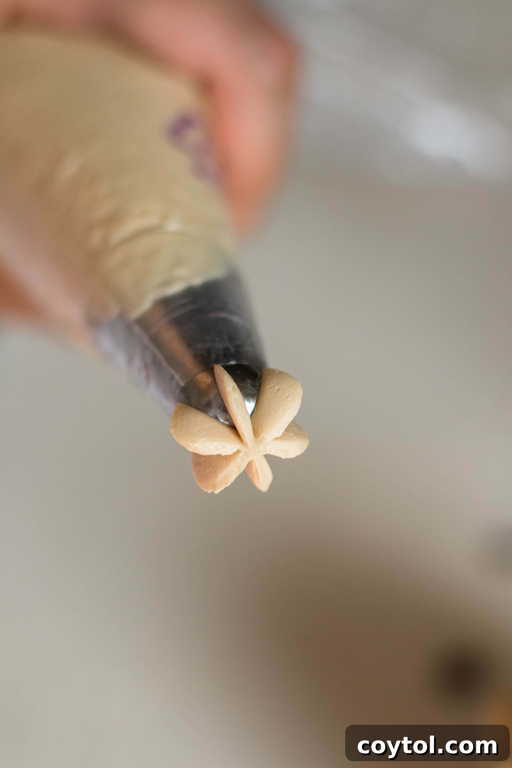 Coffee frosting in a piping bag, ready to decorate a cake or cupcakes.