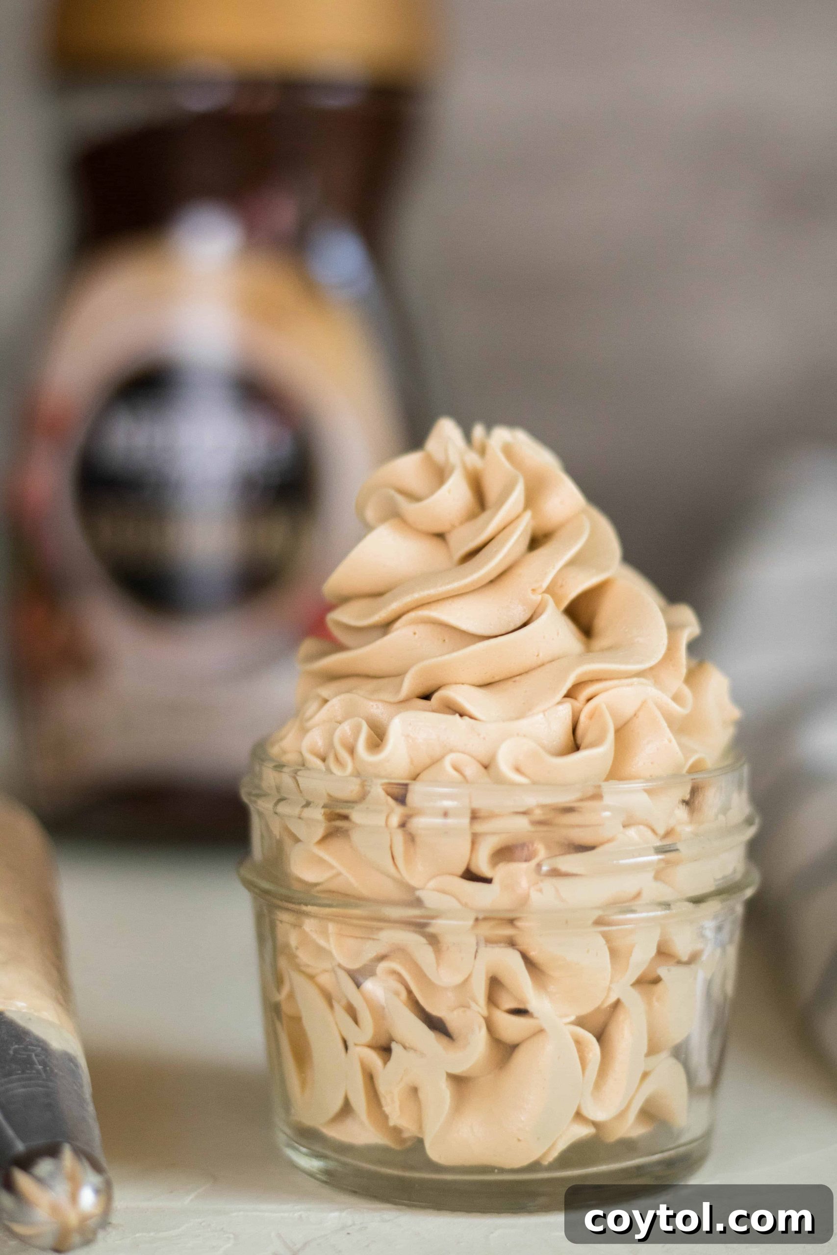 Coffee frosting on a beautifully decorated cake, showcasing its smooth texture.