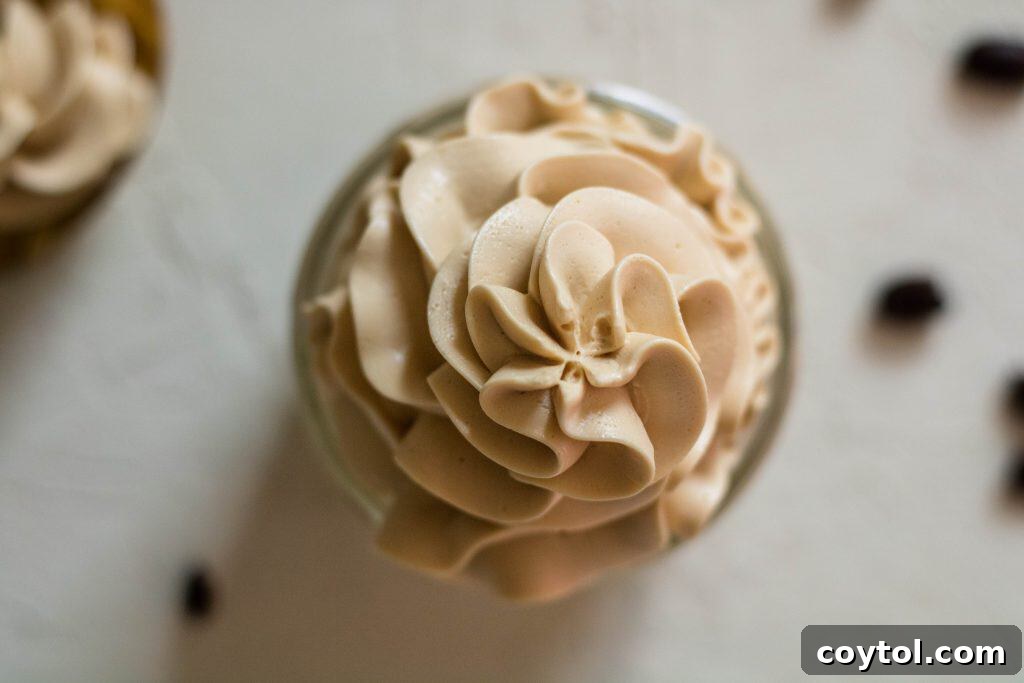 Overhead shot of rich, golden coffee frosting recipe in a bowl, ready for spreading.