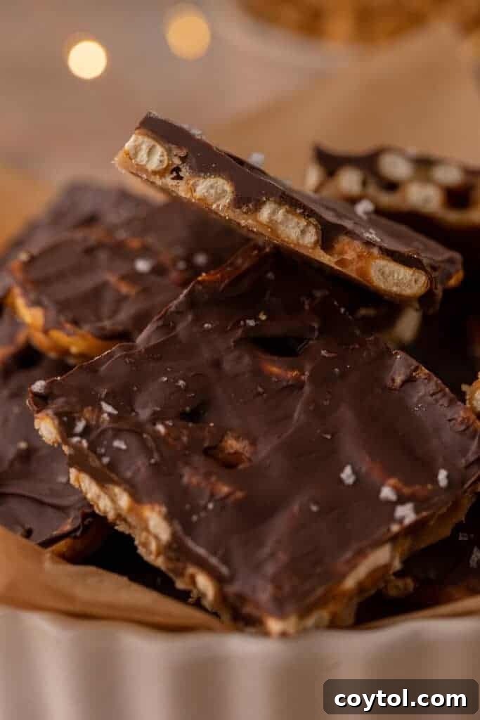 Close-up of Christmas treat pieces stacked in a dish with sea salt on top.