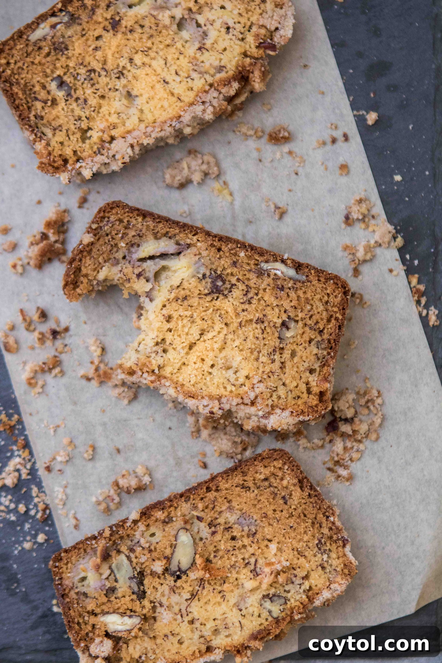 A delectable loaf of pecan banana bread, generously adorned with a streusel topping.