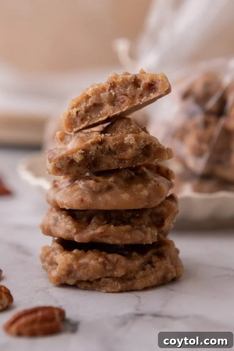 A beautiful stack of traditional New Orleans pralines, showcasing their rustic texture and abundant pecans.