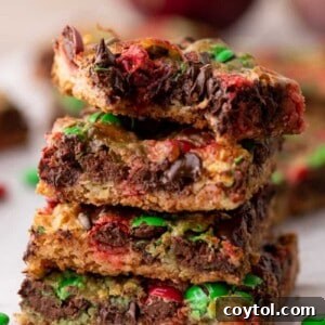A stack of Christmas Magic Cookie Bars on top of each other, showcasing their layers