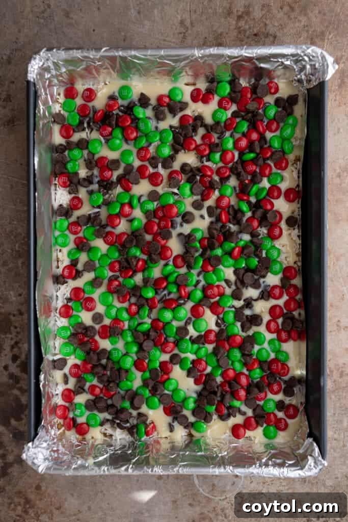 Unbaked Christmas Magic Cookie Bars in a pan, fully layered