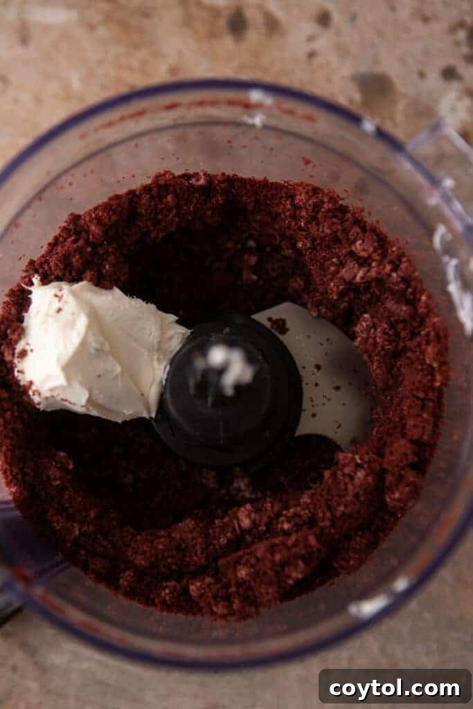 oreo and cream cheese being blended together in a food processor