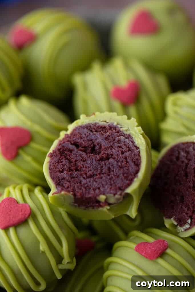 a truffle ball split in half, sitting on top of other balls, displaying its rich texture