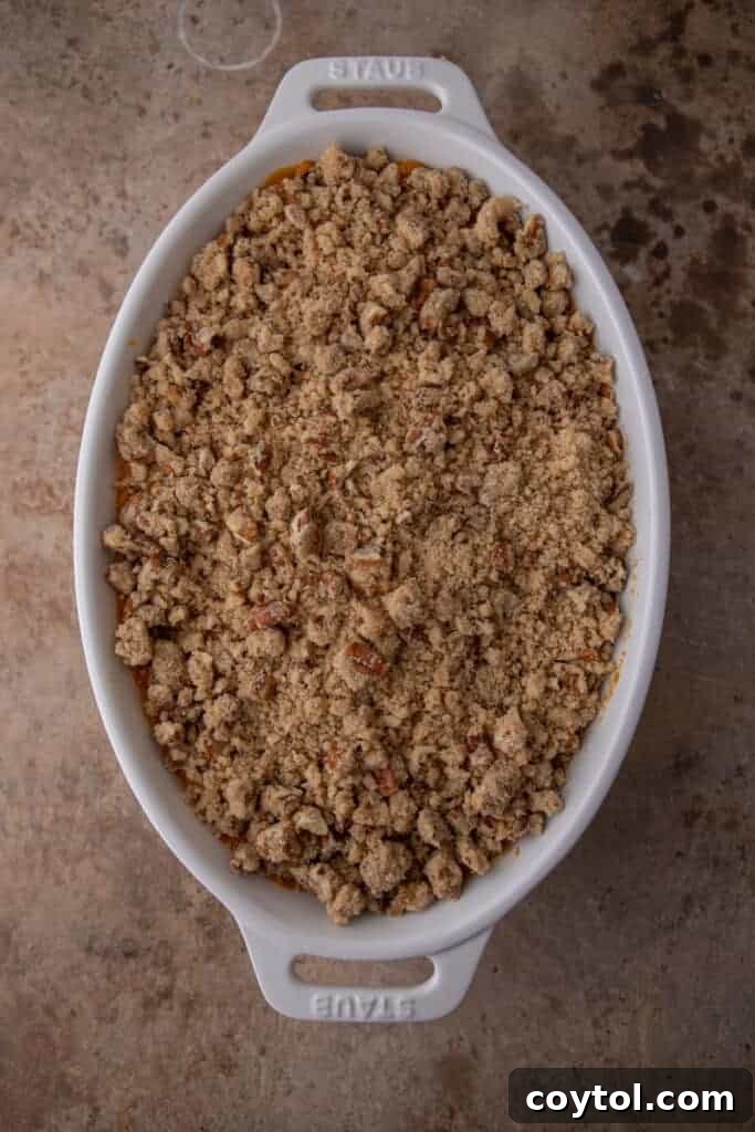 A fully baked sweet potato casserole with a golden-brown and crunchy pecan topping, ready to be served.