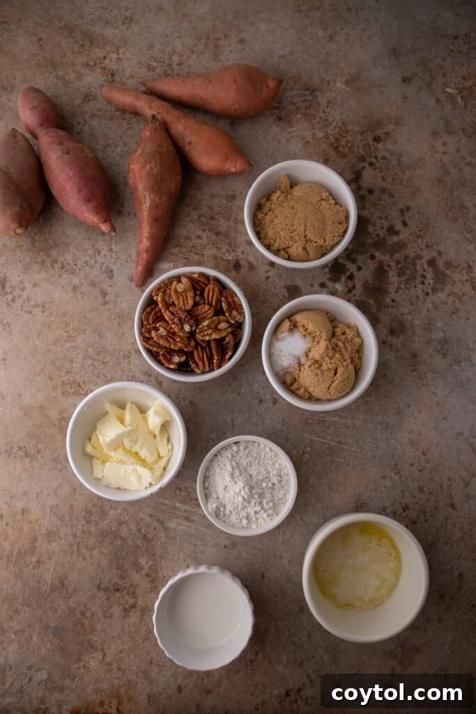 A colorful array of fresh ingredients for sweet potato casserole with pecans, including whole sweet potatoes, pecans, butter, eggs, and spices, laid out on a kitchen counter.