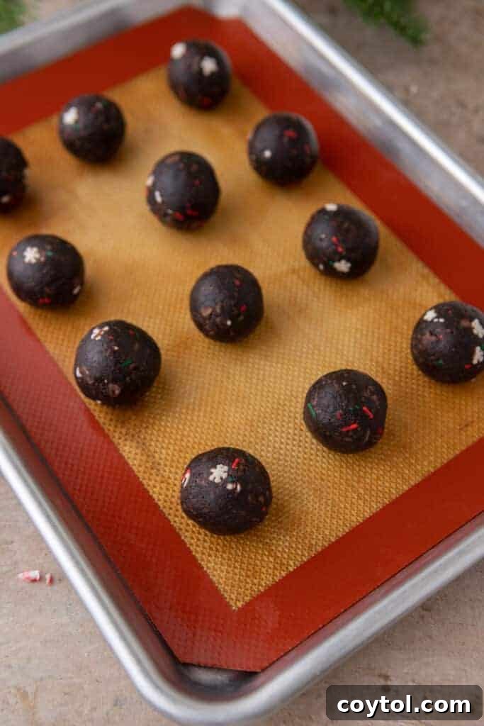 cake balls lined up on a baking sheet