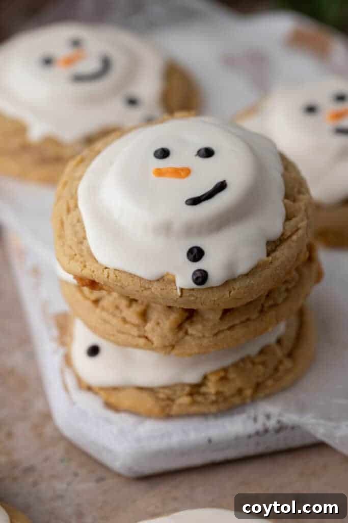 angled overhead shot of three melted snowman peanut butter cookies