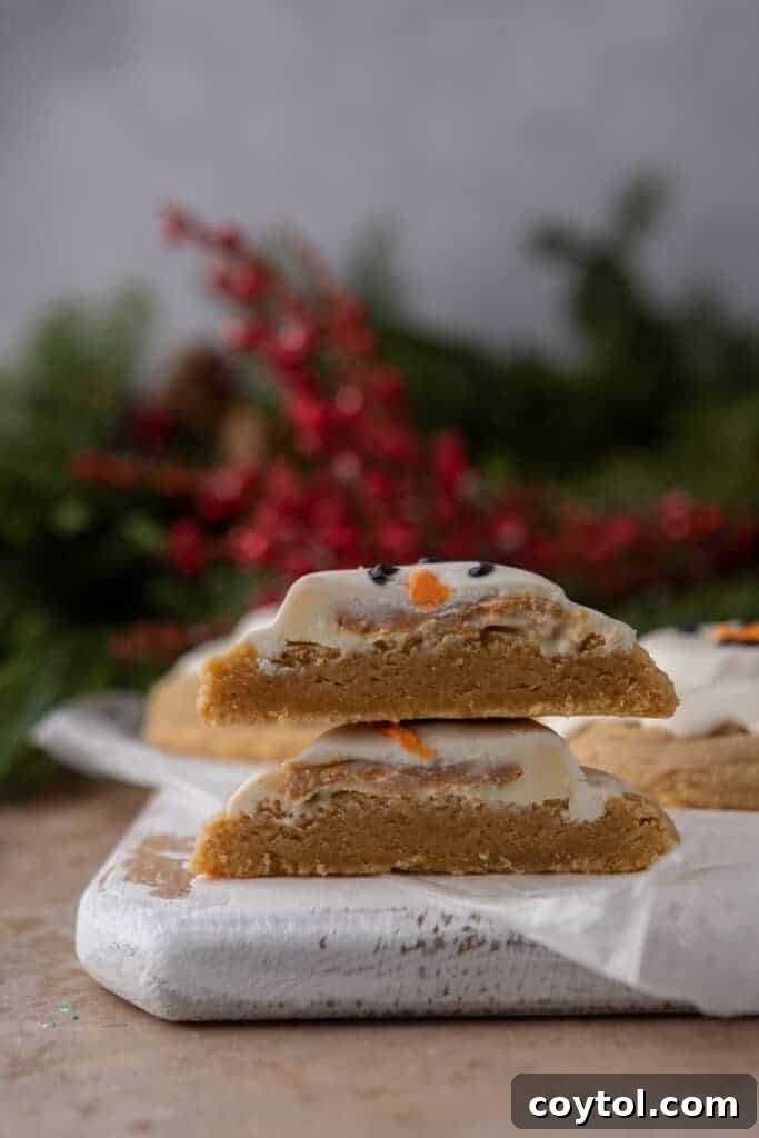 two halves of a melted snowman peanut butter cookie stacked on top of each other