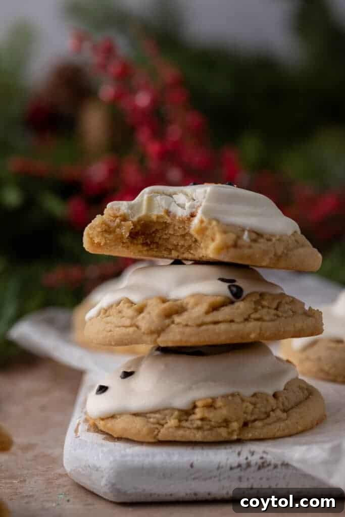 three melted snowman peanut butter cookies stacked on top of one another