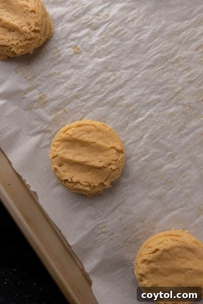 pressed cookie dough on a lined baking sheet