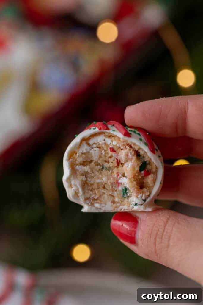 Whip Up Little Debbie Christmas Tree Cake Truffles No Baking Required 5 a hand holding up a half of a little debbie christmas tree cakes truffles