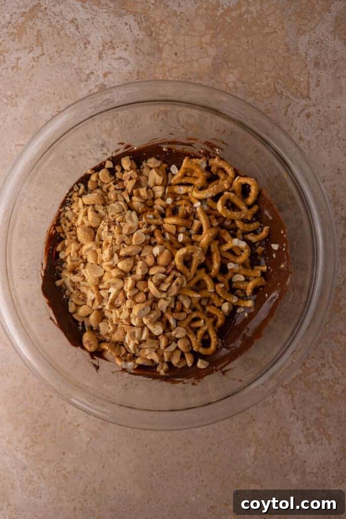 Unmixed ingredients for Christmas bark in a clear bowl before melting