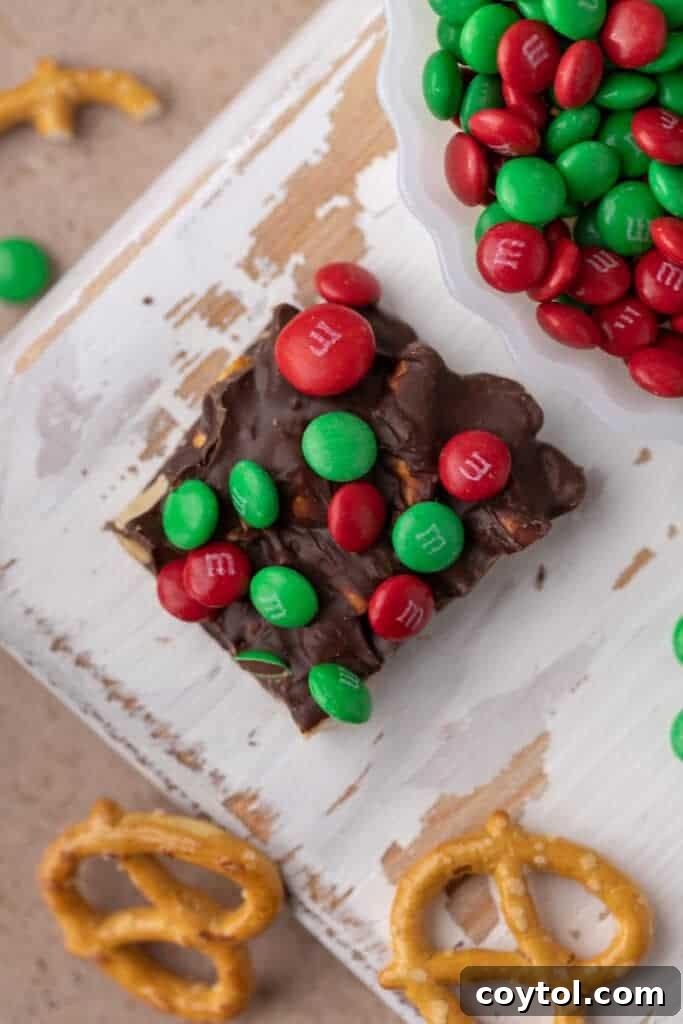 Close up of a single square of Christmas peanut pretzel M&M's bark showing the texture