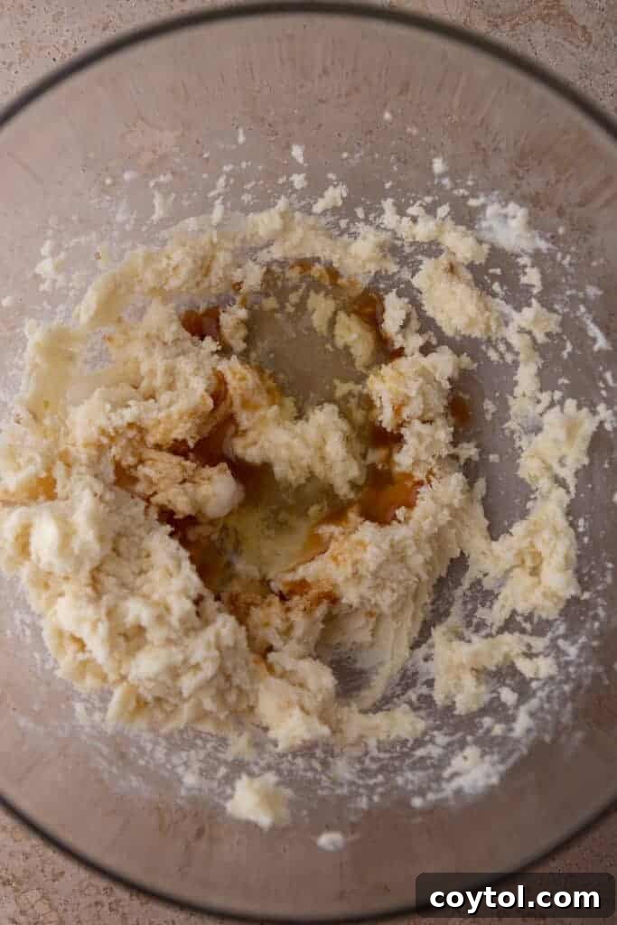 Wet ingredients (butter and sugars) being creamed in a mixing bowl