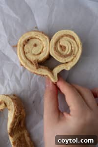 Dough fully rolled into a complete heart shape, with the bottom pinched to form the tip.