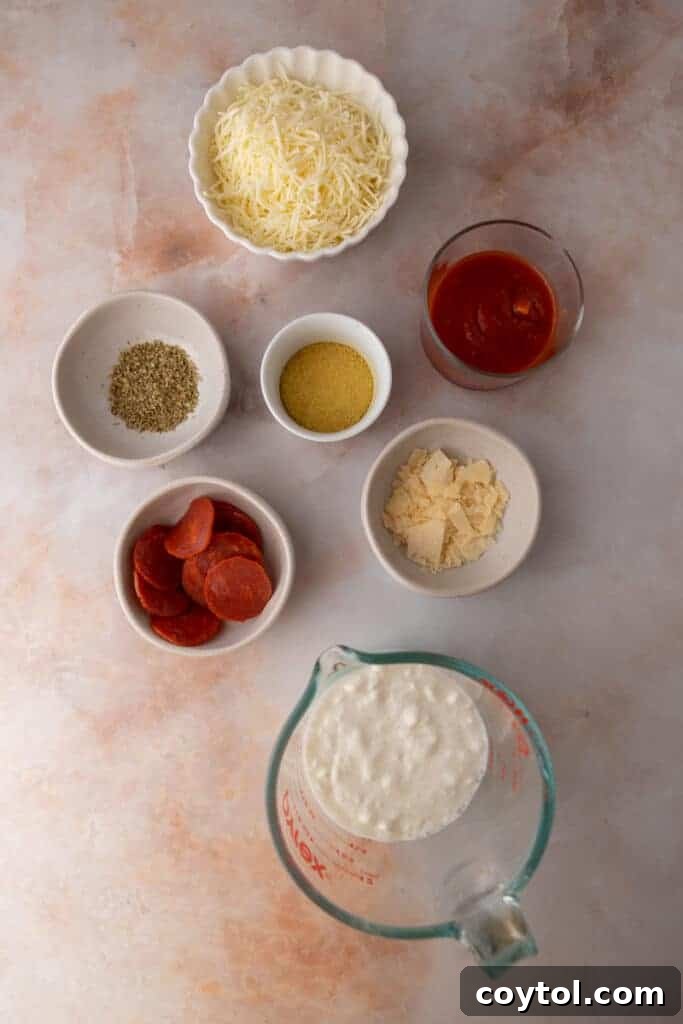 A vibrant collection of ingredients laid out for the cottage cheese pizza bowl dip recipe.