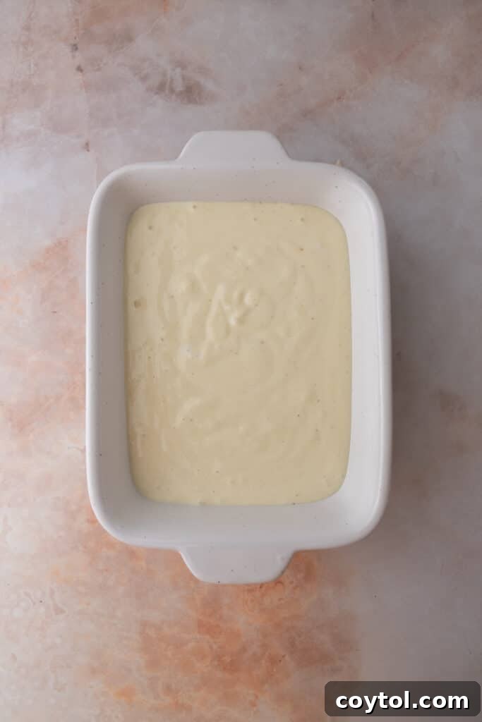 Cottage cheese being prepared in a dish.