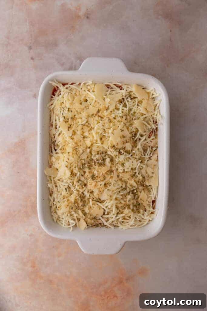 Shredded mozzarella and Parmesan cheese layered over the marinara sauce.