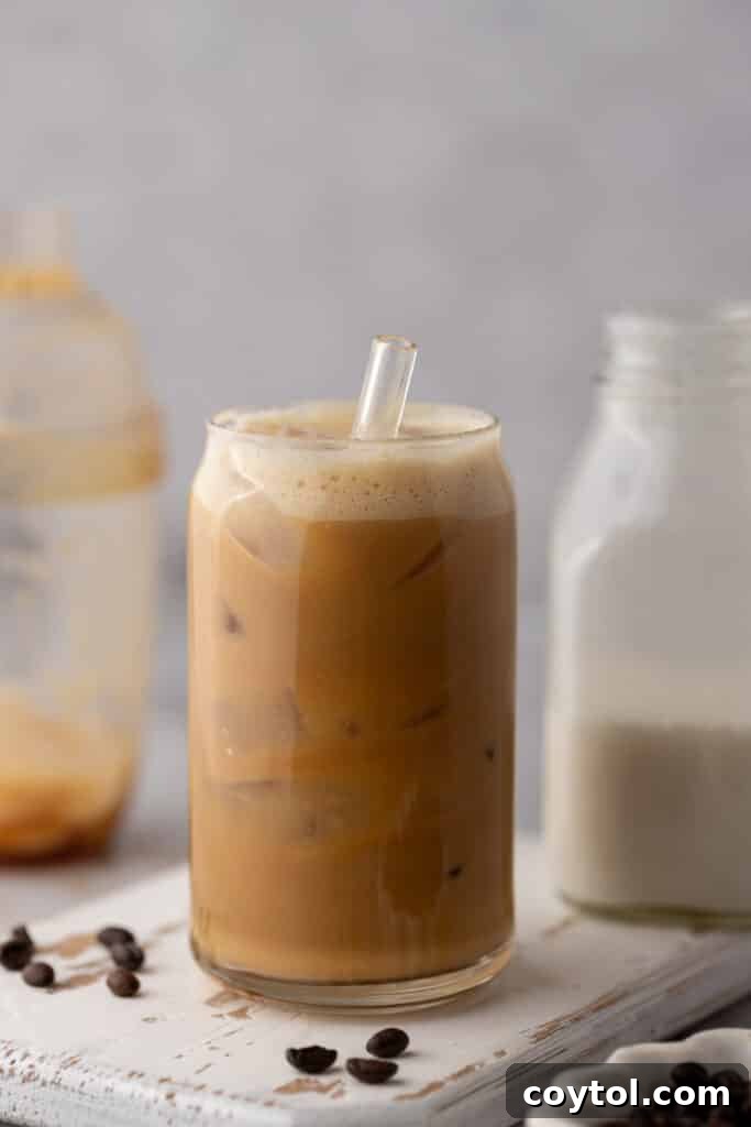 A wide shot capturing the full presentation of an Iced Hazelnut Oatmilk Shaken Espresso Starbucks copycat drink, highlighting its inviting appearance.