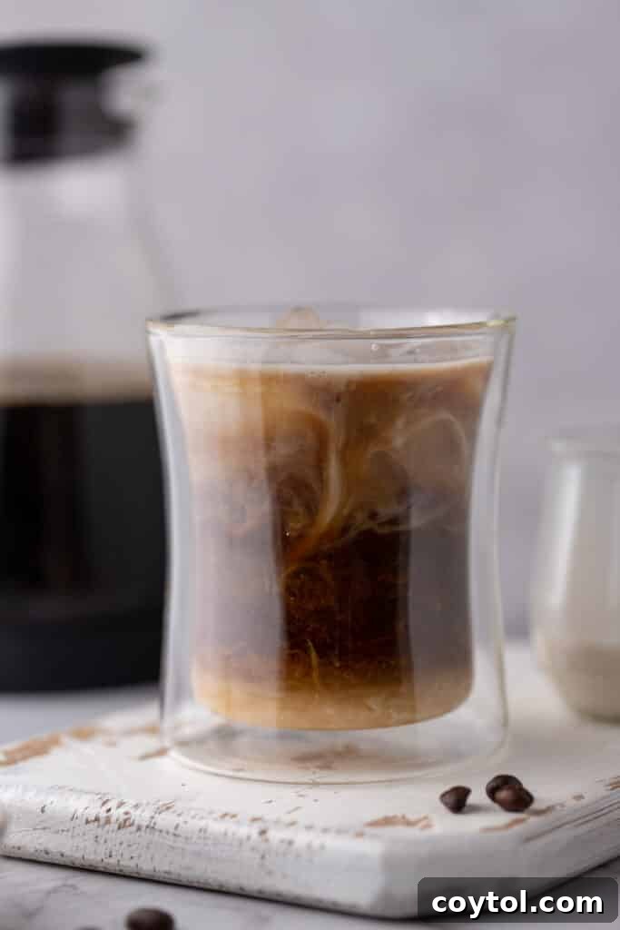 Person making coffee in a French press at home