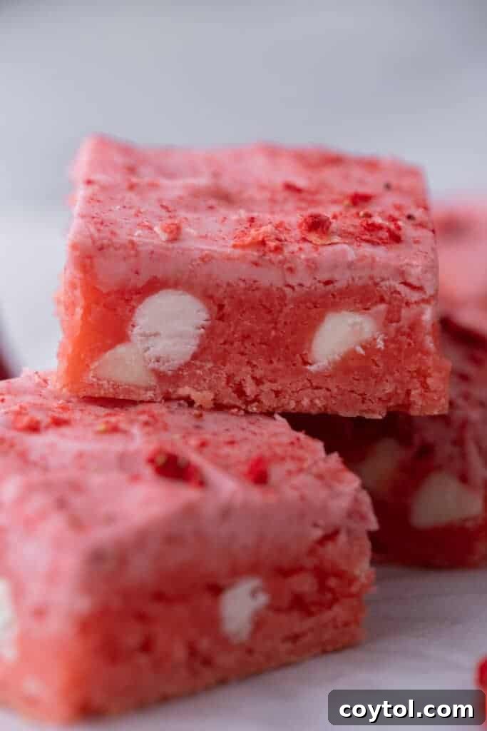 Two perfectly glazed strawberry brownies stacked, ready to be enjoyed.