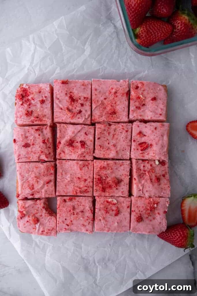 Strawberry brownies neatly cut into perfect squares, showcasing their uniform size and inviting glaze.