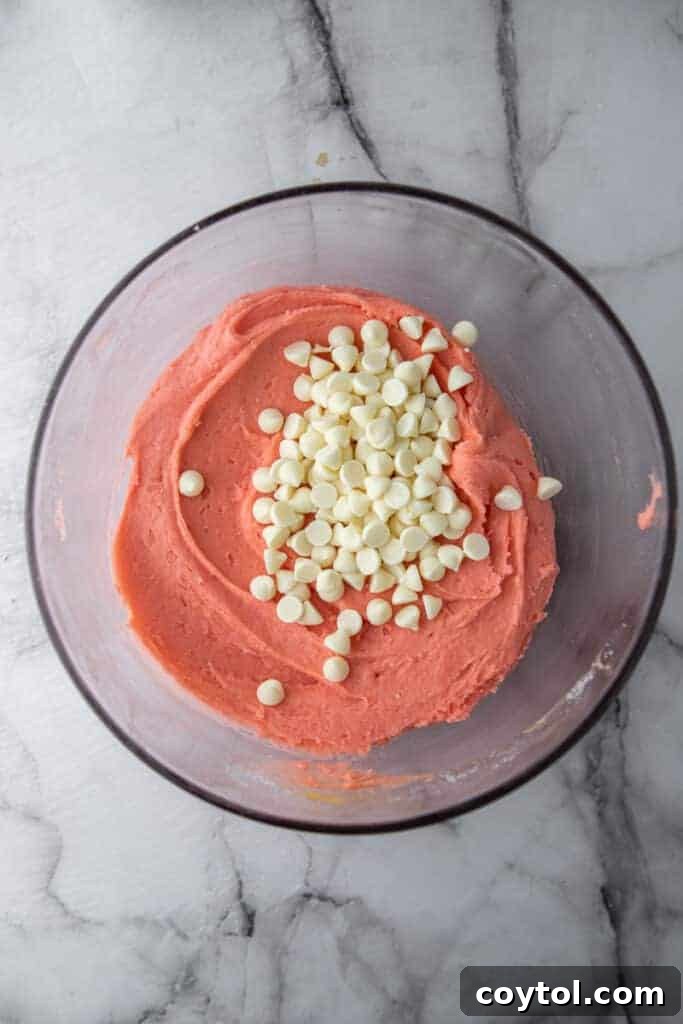 Mixed strawberry brownie batter in a bowl, showing its pink color and smooth texture.