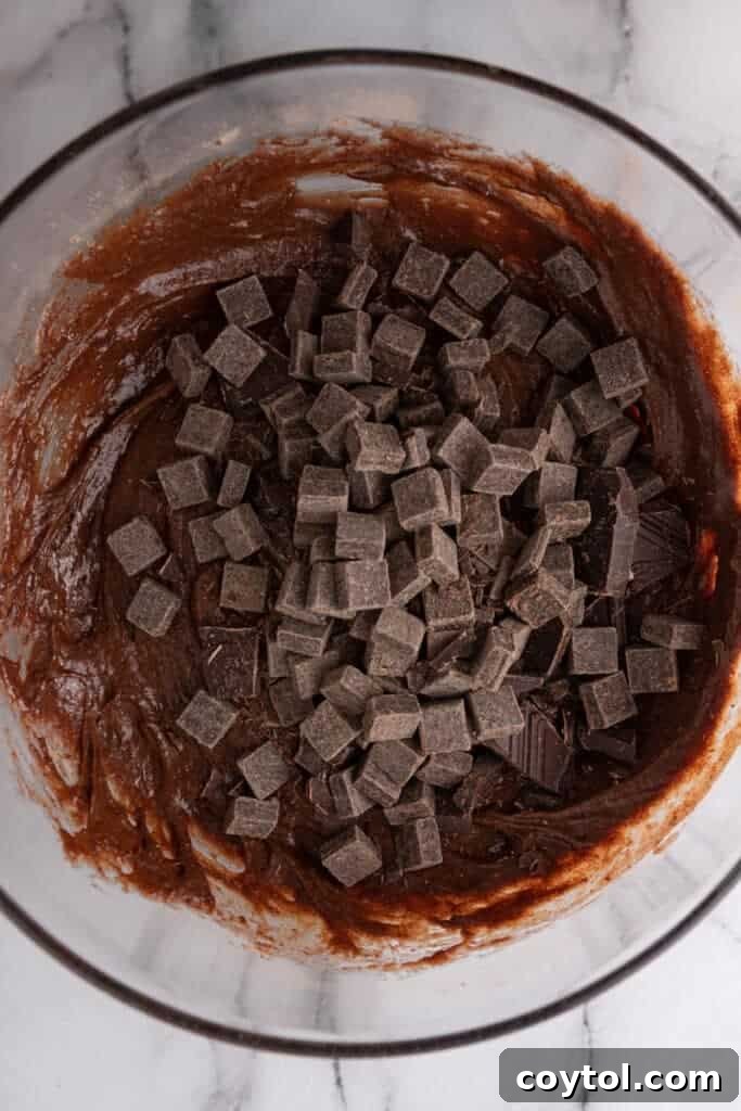 chocolate chunks being added to the batter