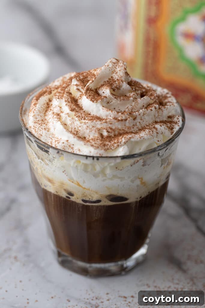 Angled shot of a delicious Einspanner coffee with whipped cream on top, ready to be enjoyed.