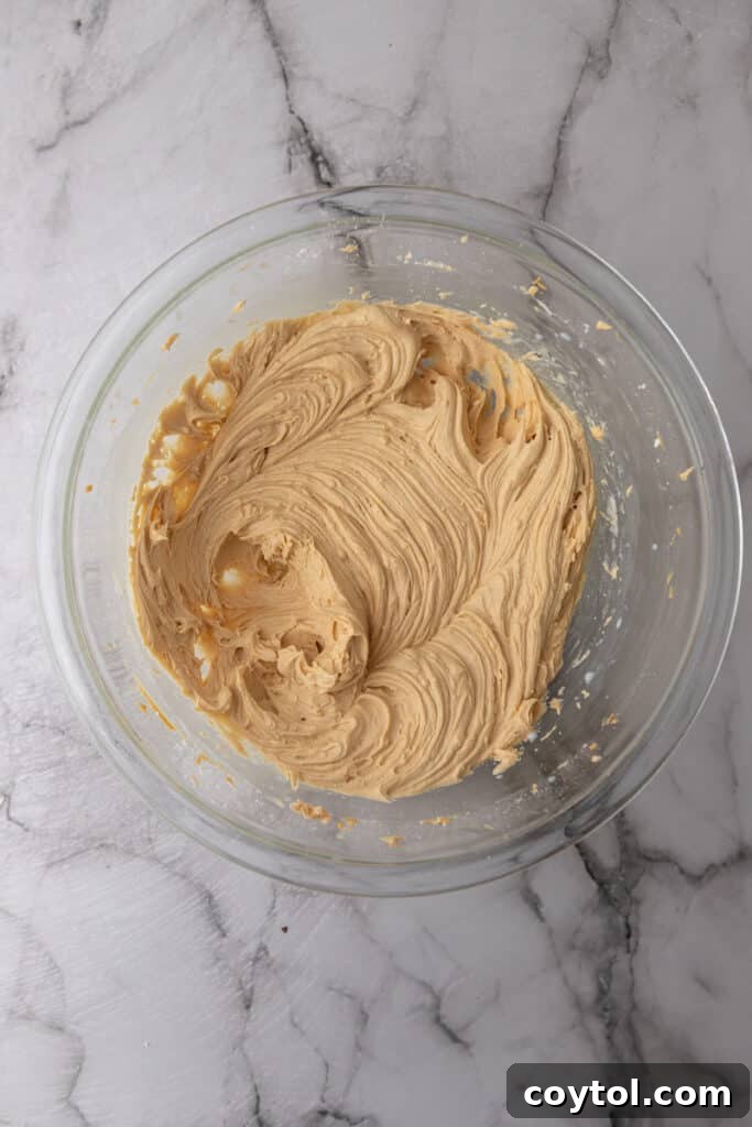 Finished peanut butter frosting in a bowl, ready for use, showing its creamy texture.