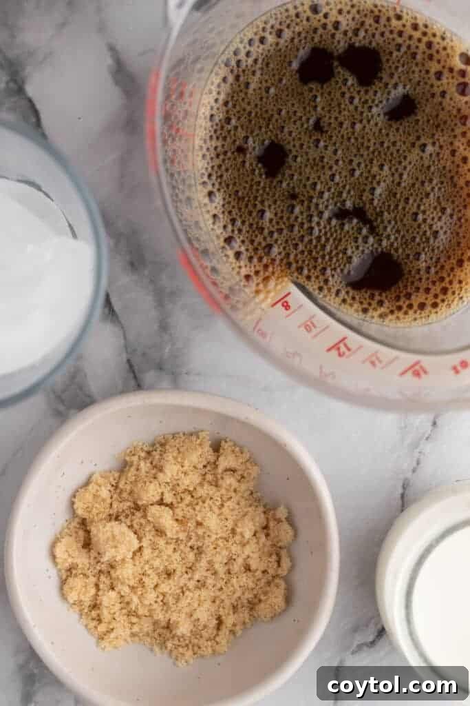 Effortless Homemade Brown Sugar Iced Coffee Indulgence 3 Fresh ingredients laid out for making brown sugar iced coffee, including coffee beans, brown sugar, a glass, and half-and-half.