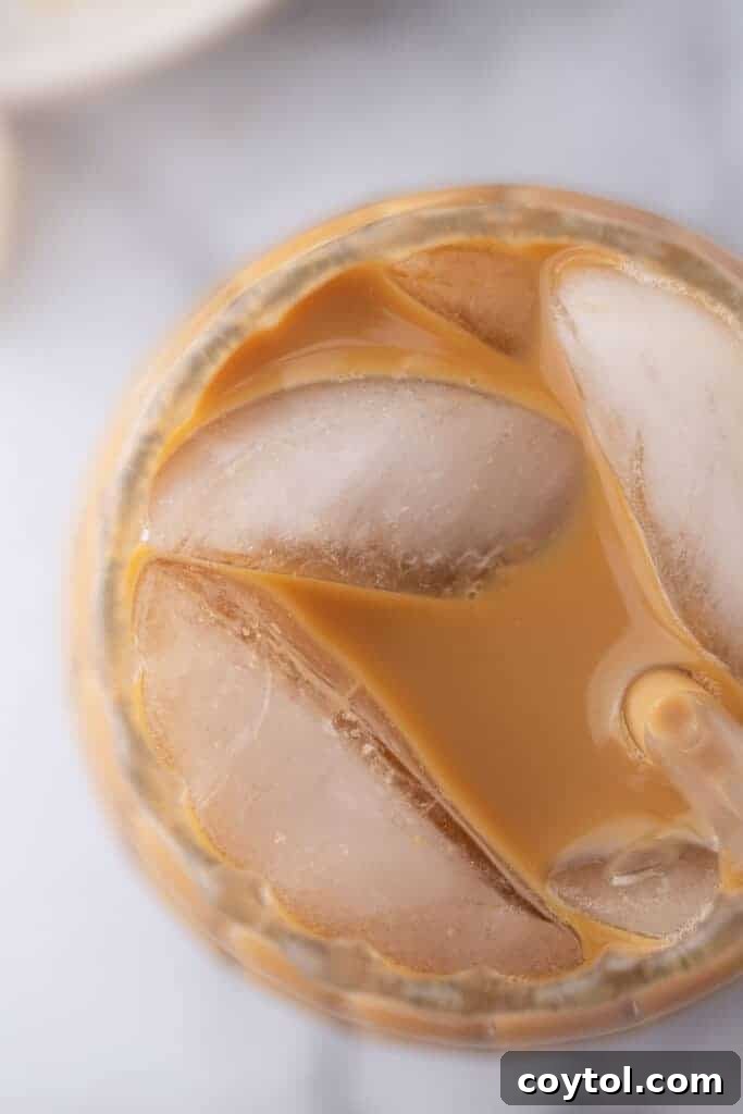 Effortless Homemade Brown Sugar Iced Coffee Indulgence 4 Close-up overhead shot of a glass of brown sugar iced coffee, showcasing its creamy texture and rich color.