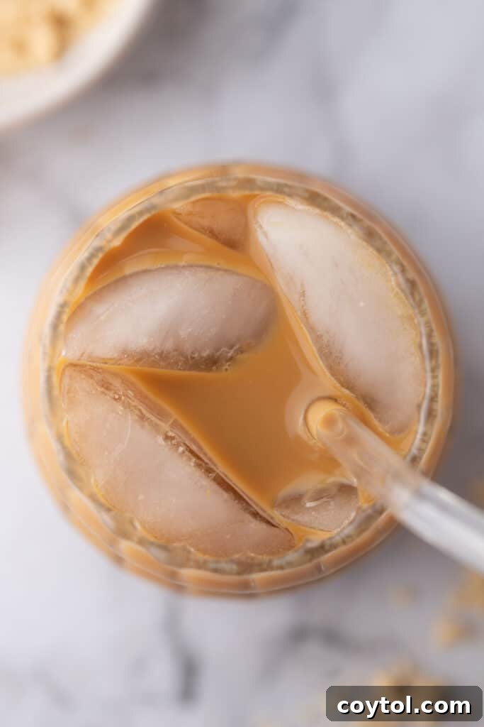 Effortless Homemade Brown Sugar Iced Coffee Indulgence 9 Overhead view of the brown sugar iced coffee with a foamy top and a straw.