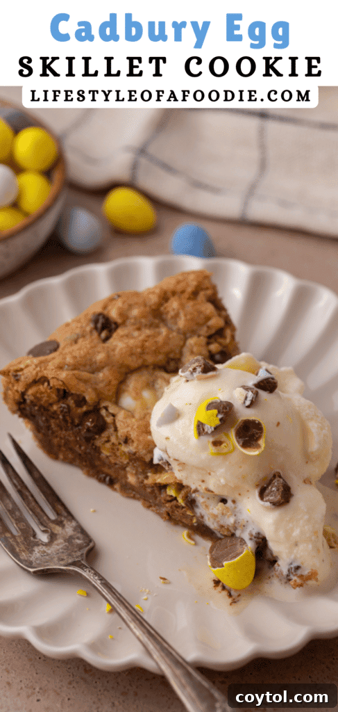 Another vertical image of the Cadbury Mini Egg Skillet Cookie, highlighting its rich, chewy texture and colorful candy pieces for a festive touch.