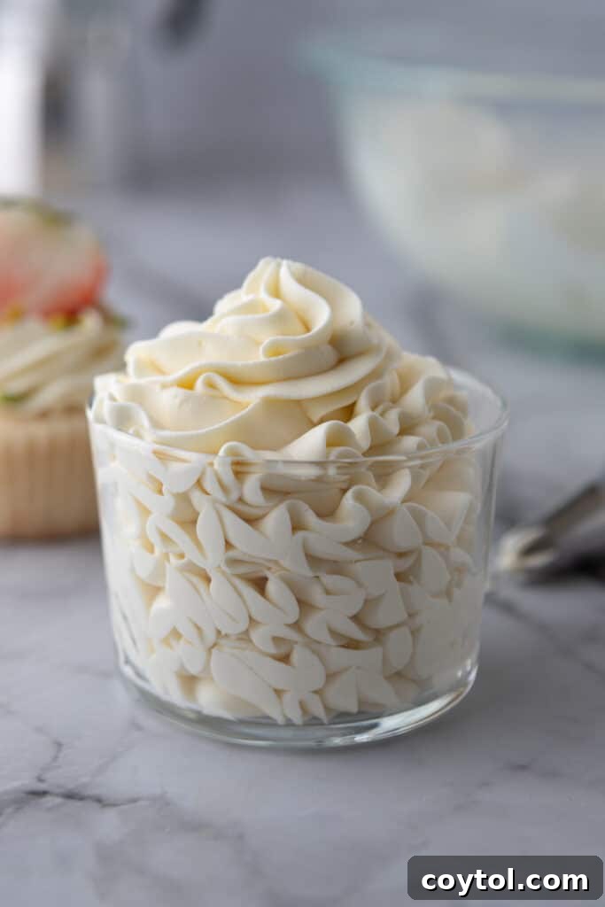 Mascarpone cake frosting in a clear glass cup, showcasing its creamy texture