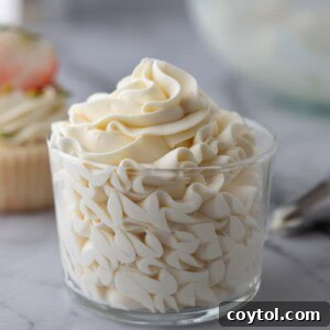 Mascarpone cake frosting in a glass cup, showcasing its creamy texture