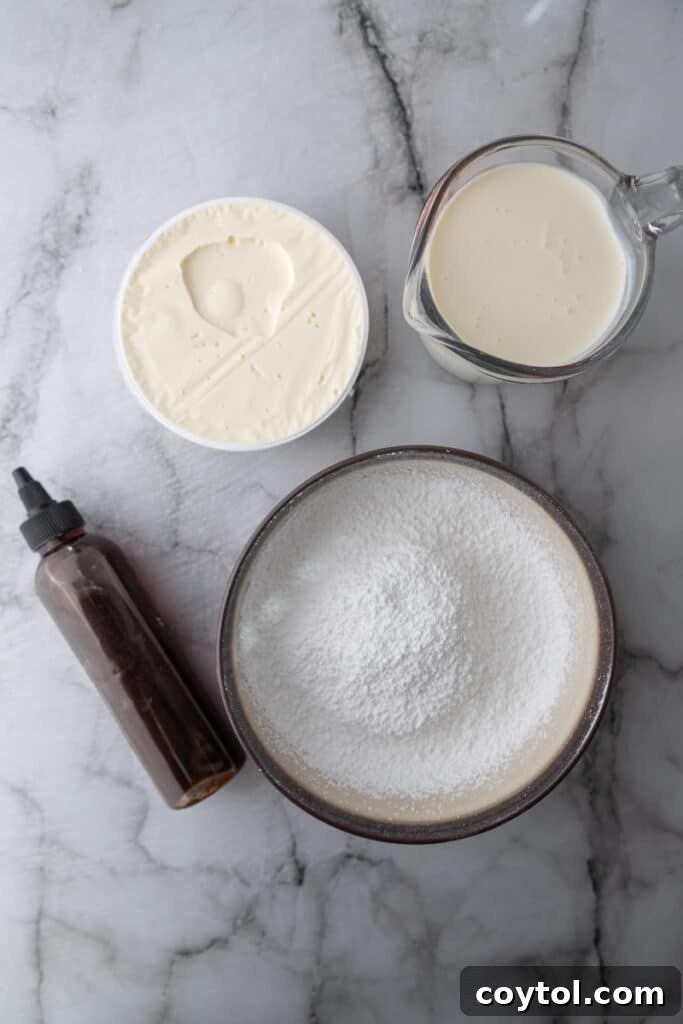 A selection of ingredients for mascarpone cake frosting, including mascarpone cheese, heavy cream, powdered sugar, vanilla extract, and salt.
