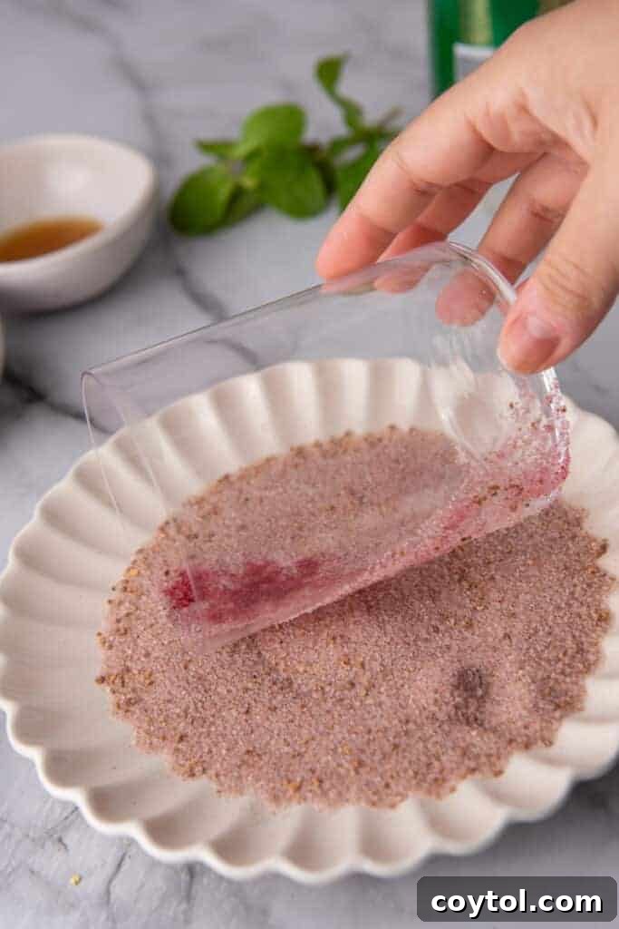 glass being dipped in sanding sugar