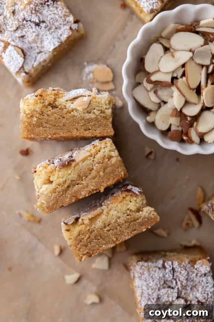 Almond croissant blondies standing on their sides, showing their cross-section.