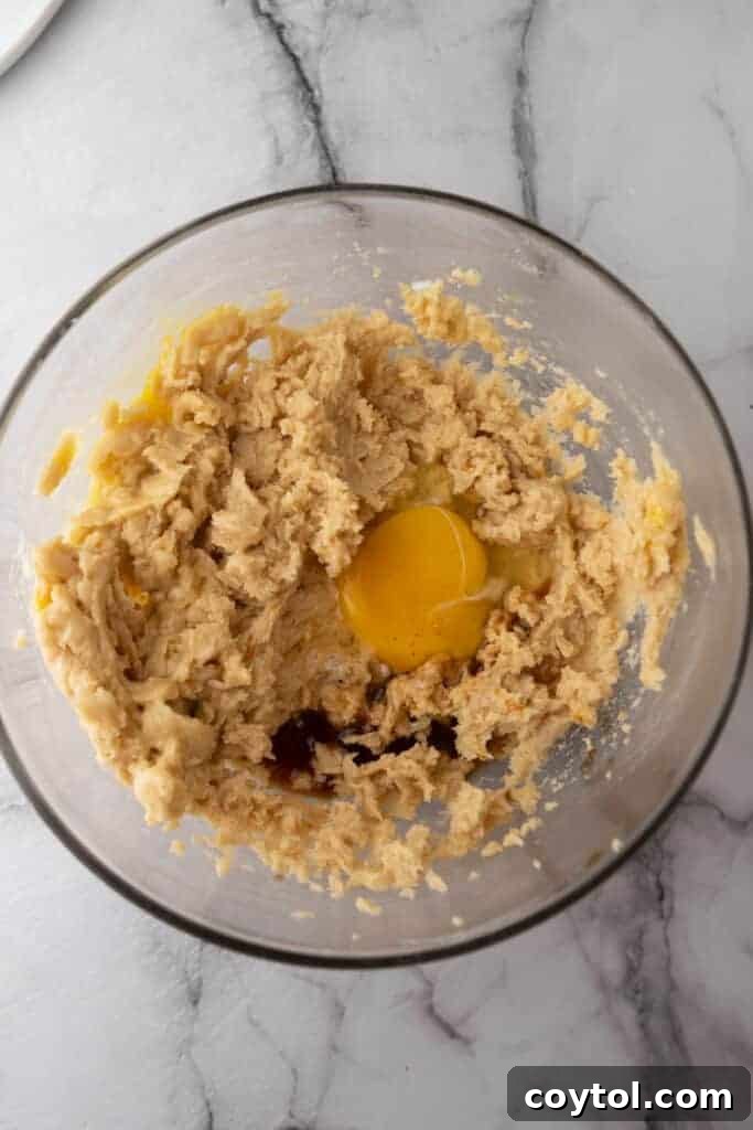 The Ultimate Soft and Chewy Nestle Toll House Cookie Bars 5 Wet ingredients for cookie bars being creamed in a bowl