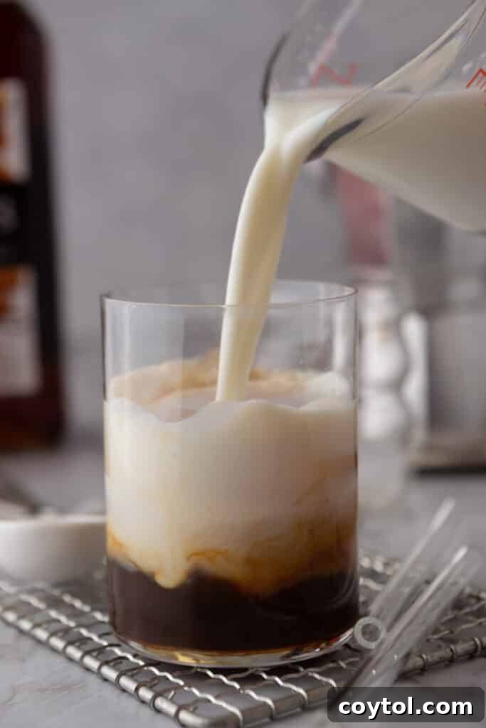 Hand pouring milk into a glass