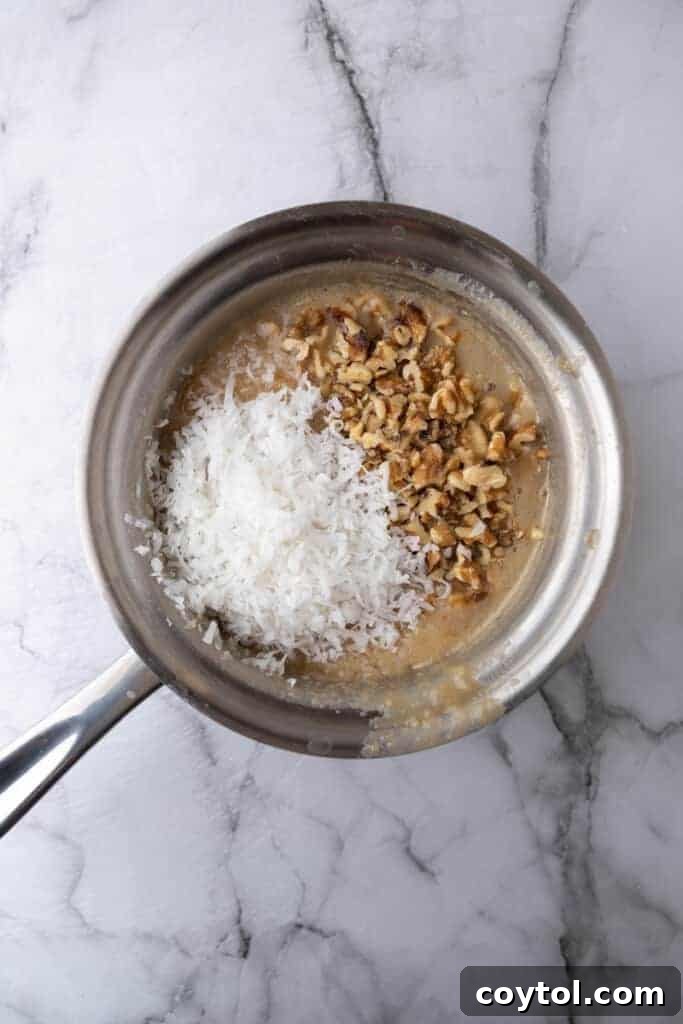 A saucepan containing the initial ingredients for the boiled coconut icing, before being brought to a boil.