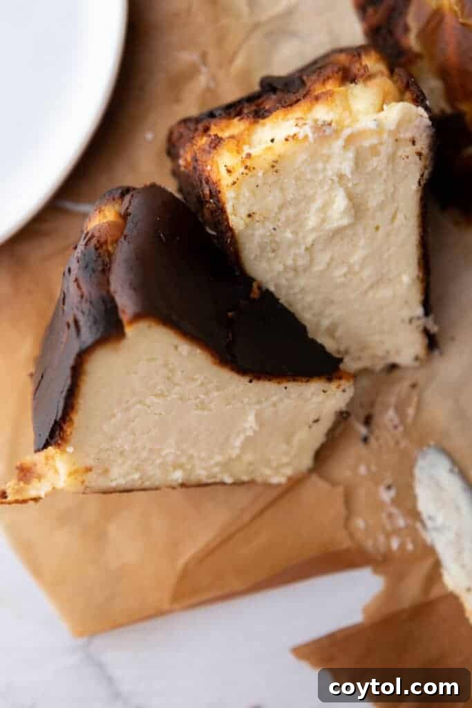 Slices of a perfectly baked 6-inch burnt Basque cheesecake on parchment paper, ready to be served.