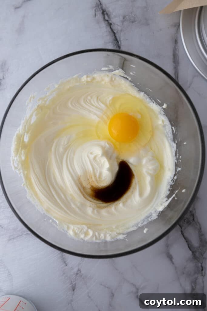 Ingredients for Basque cheesecake unmixed in a bowl, showing distinct components.