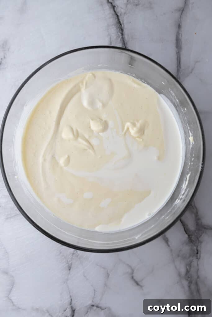 Smooth, raw Basque cheesecake batter in a mixing bowl, ready for pouring.