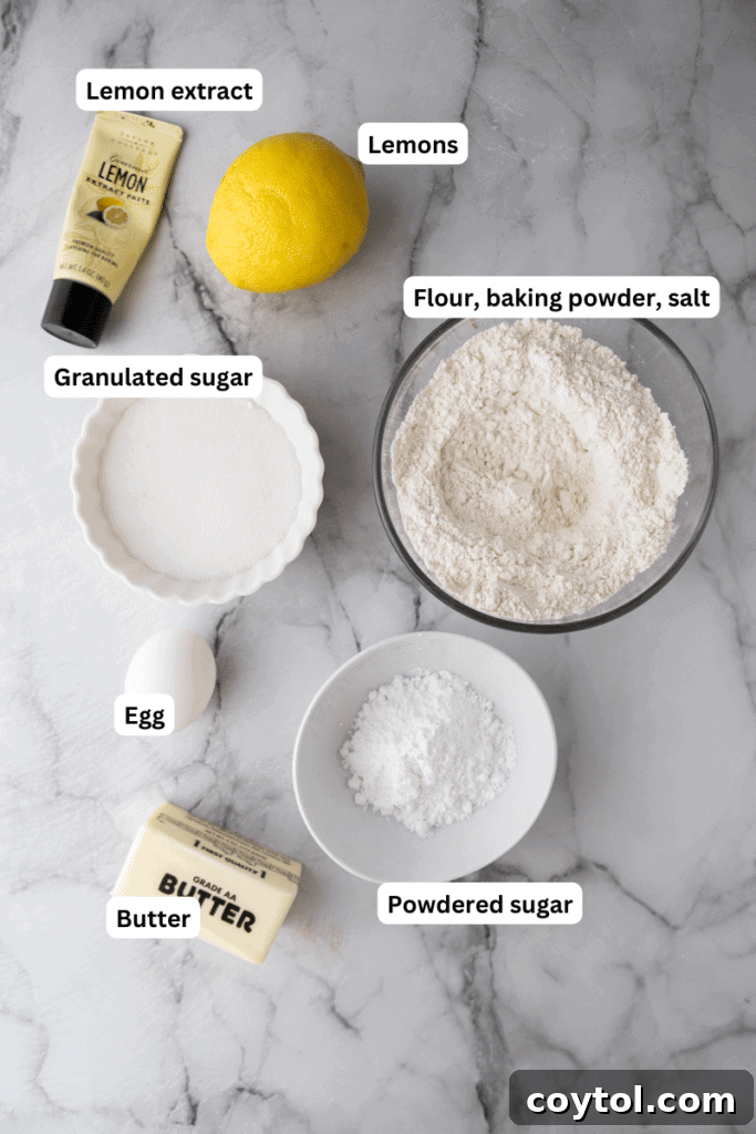 Various baking ingredients including butter, sugar, lemons, and flour laid out on a kitchen counter