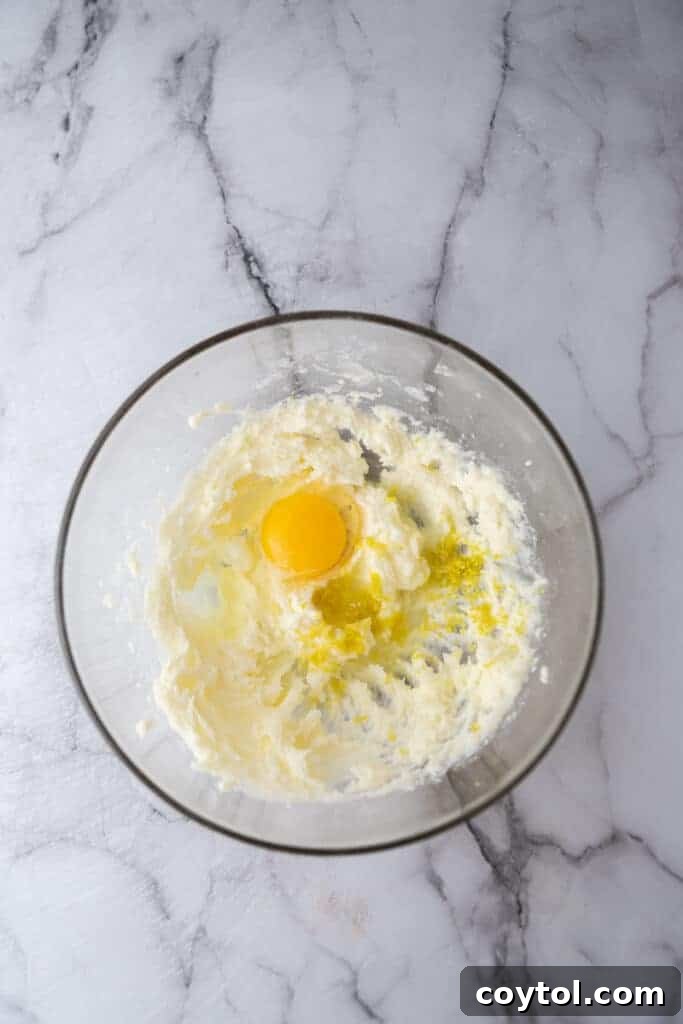 Close-up of softened butter being creamed in a bowl with an electric mixer